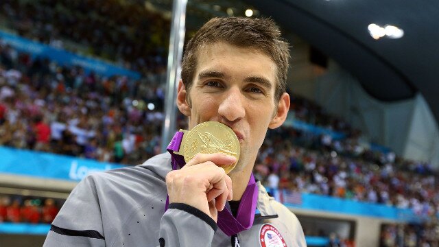 Michael Phelps kissing gold medal