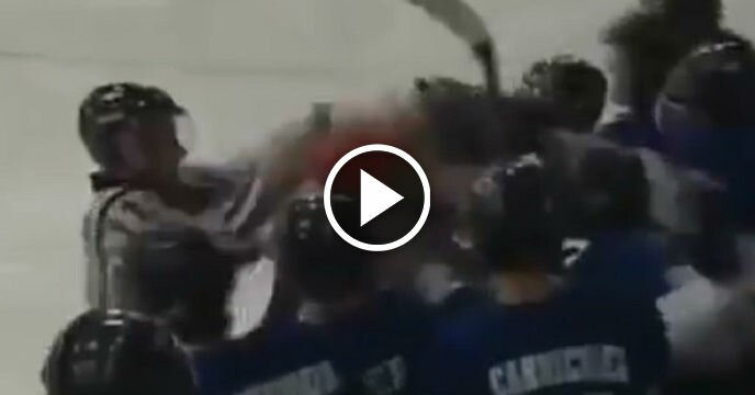 Hockey Player Starts Chasing Skater on Opposing Team and Incites a Massive Brawl on the Bench