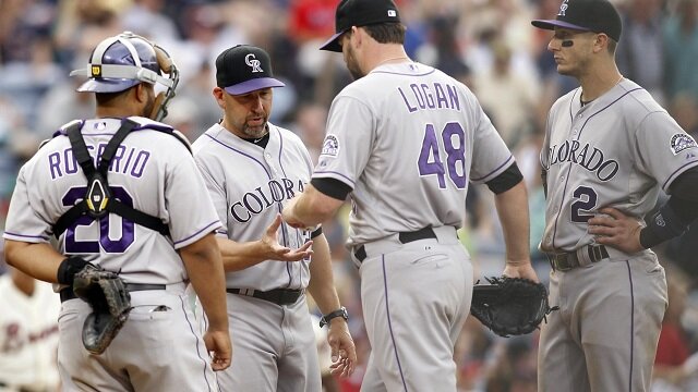 Colorado Rockies manager Walt Weiss (22) takes relief pitcher Boone Logan (48) out of the game against the Atlanta Braves in the eighth inning at Turner Field. 