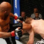 Demetrious Johnson kicks Ali Bagautinov during flyweight title fight at UFC 174