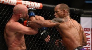 Hector Lombard punches Josh Burkman during welterweight contest at UFC 182