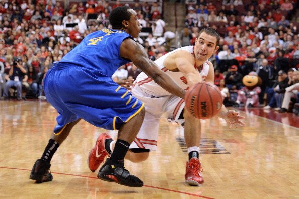 COLUMBUS, OH - DECEMBER 18: Aaron Craft #4 of the Ohio State Buckeyes attempts a pass around the defense of Jarvis Threatt #4 of the Delaware Blue Hens in the second half on December 18, 2013 at Value City Arena in Columbus, Ohio. Ohio State defeated Delaware 76-64. (Photo by Jamie Sabau/Getty Images)