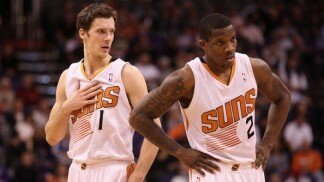 PHOENIX, AZ - DECEMBER 18: Goran Dragic #1 and Eric Bledsoe #2 of the Phoenix Suns await a free throw shot during the NBA game against the San Antonio Spurs at US Airways Center on December 18, 2013 in Phoenix, Arizona. The Spurs defeated the 108-101. NOTE TO USER: User expressly acknowledges and agrees that, by downloading and or using this photograph, User is consenting to the terms and conditions of the Getty Images License Agreement. (Photo by Christian Petersen/Getty Images)