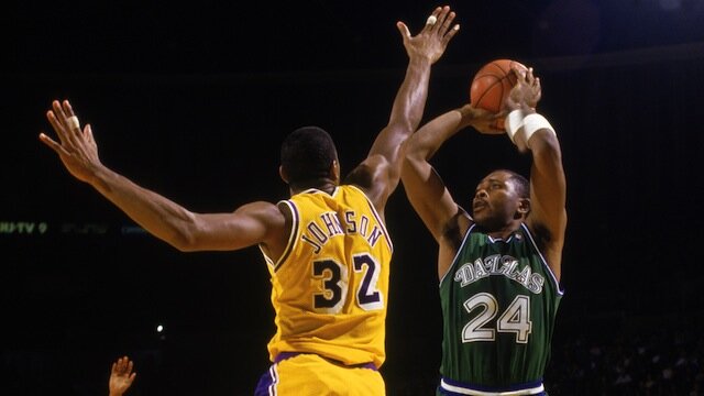 Mark Aguirre shoots over Earvin 