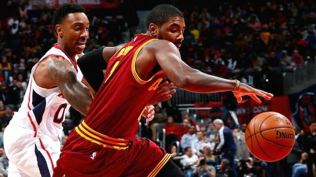 Kyrie Irving of the Cleveland Cavaliers drives past Jeff Teague of the Atlanta Hawks at Philips Arena on December 30, 2014 in Atlanta, Georgia. (Photo by Kevin C. Cox/Getty Images)
