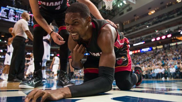 Nov 9, 2014; Dallas, TX, USA; Miami Heat center Chris Bosh (1) falls to the floor with an apparent injury during the second half against the Dallas Mavericks at the American Airlines Center. The Heat defeated the Mavericks 105-96. Mandatory Credit: Jerome Miron-USA TODAY Sports