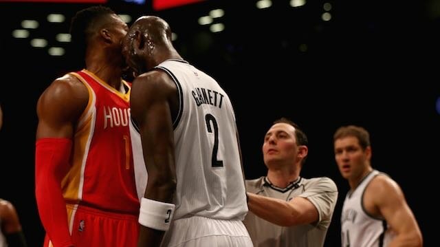 Kevin Garnett (left) of the Brooklyn Nets head butts Dwight Howard of the Houston Rockets in the first quarter after the two were in a shoving match at the Barclays Center on January 12, 2015 in the Brooklyn borough of New York City. (Photo by Elsa/Getty Images)