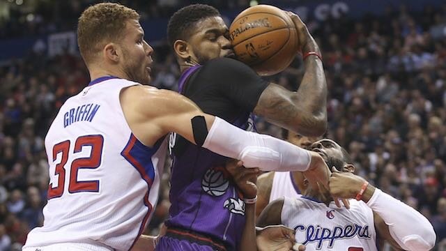 Toronto Raptors forward Amir Johnson (15) comes up with a rebound against Los Angeles Clippers forward Blake Griffin (32) and point guard Chris Paul (3) at Air Canada Centre. Mandatory Credit: Tom Szczerbowski-USA TODAY Sports