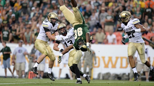 Sep 1, 2013; Denver, CO, USA; Colorado State Rams tight end Kivon Cartwright (86) is flipped upside down going for a reception while Colorado Buffaloes linebacker Addison Gillam (44) and defensive back Parker Orms (13) and defensive back Jered Bell (21) observe during the game at Sports Authority Field at Mile High. Mandatory Credit: Ron Chenoy-USA TODAY Sports