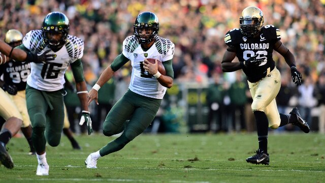 Oct 5, 2013; Boulder, CO, USA; Oregon Ducks quarterback Marcus Mariota (8) heads to the end zone for a touchdown run in the second quarter against the Colorado Buffaloes at Folsom Field. Mandatory Credit: Ron Chenoy-USA TODAY Sports
