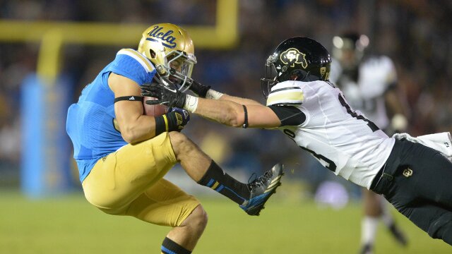Nov 2, 2013; Pasadena, CA, USA; UCLA Bruins receiver Grayson Mazzone (83) is defended by Colorado Buffaloes safety Parker Orms (13) on a 20-yard reception at Rose Bowl. UCLA defeated Colorado 45-23. Mandatory Credit: Kirby Lee-USA TODAY Sports