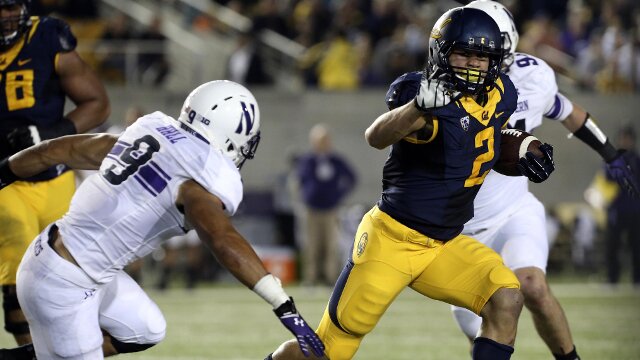 Aug 31, 2013; Berkeley, CA, USA; California Golden Bears running back Daniel Lasco (2) carries the ball against Northwestern Wildcats safety Jimmy Hall (9) during the third quarter at Memorial Stadium. Northwestern won 44-30. Mandatory Credit: Kelley L Cox-USA TODAY Sports
