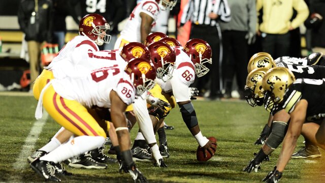 Nov 23, 2013; Boulder, CO, USA; Southern California Trojans quarterback Cody Kessler (6) lines up under center across from the Colorado Buffaloes in the fourth quarter at Folsom Field. The Trojans defeated the Buffaloes 47-29. Mandatory Credit: Ron Chenoy-USA TODAY Sports