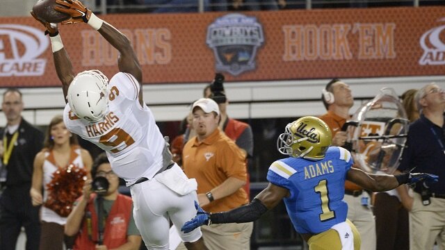 Texas Longhorns wide receiver John Harris (9) makes a catch against UCLA Bruins defensive back Ishmael Adams (1) during the second quarter at AT&T Stadium. 