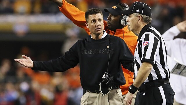 Oklahoma State Cowboys head coach Mike Gundy argues with an official during the first half against the Missouri Tigers in the 2014 Cotton Bowl at AT&T Stadium