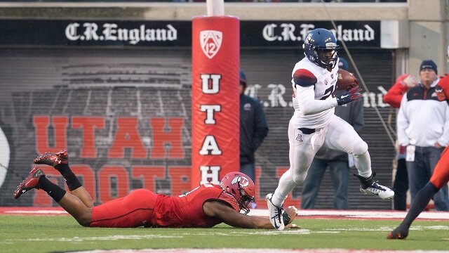Arizona Wildcats running back Nick Wilson (28) avoids the tackle of Utah Utes defensive end Nate Orchard (8) during the first half at Rice-Eccles Stadium. 