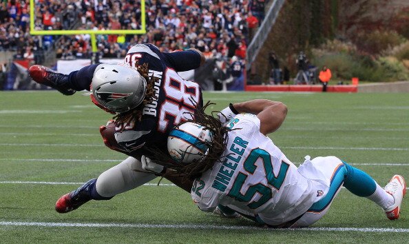 FOXBORO, MA - OCTOBER 27: Brandon Bolden #38 of the New England Patriots scores as Philip Wheeler #52 of the Miami Dolphins attempts to defend in the second half at Gillette Stadium on October 27, 2013 in Foxboro, Massachusetts. (Photo by Jim Rogash/Getty Images)