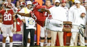 labama Crimson Tide wide receiver Amari Cooper (9) dives for a ball throw behind him during the second half of a game against the LSU Tigersat Tiger Stadium. Alabama defeated LSU 20-13.