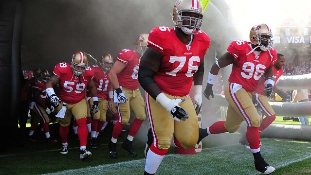 San Francisco, CA, USA; San Francisco 49ers offensive tackle Anthony Davis (76) and defensive tackle Demarcus Dobbs (96) lead their team onto the field from the player tunnel before the game against the New York Giants at Candlestick Park. The 49ers defeated the Giants 27-20.