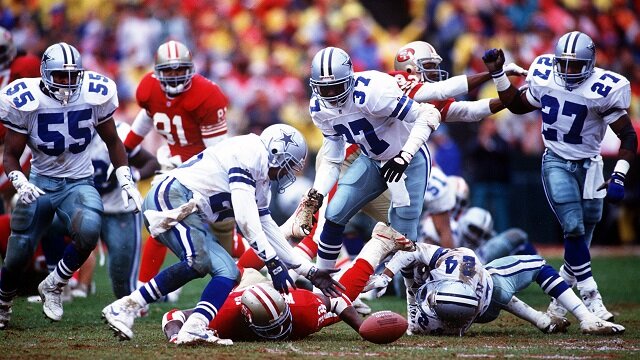 DALLAS DEFENSIVE BACK RECOVERS A FUMBLE BY SAN FRANCISCO RUNNING BACK RICKY WATTERS DURING THE COWBOYS 30-20 VICTORY OVER THE 49ERS IN THE 1993 NFC CHAMPIOSHIP GAME AT CANDLESTICK PARK IN SAN FRANCISCO, CALIFORNIA.