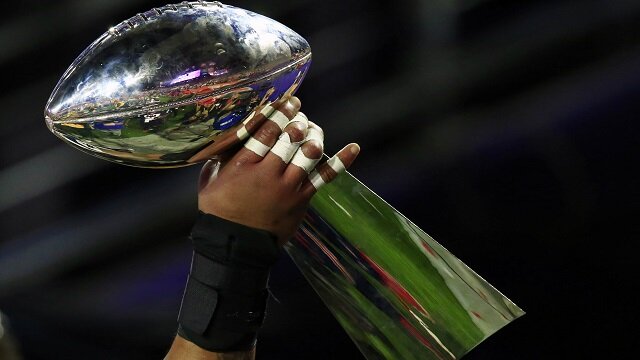 New England Patriots carry the Vince Lombardi Trophy as they celebrate their victory over the Seattle Seahawks