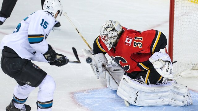 Calgary Flames netminder Karri Ramo stops San Jose's James Sheppard