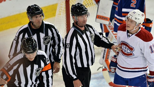 Montreal Canadiens Brendan Gallagher disputes his goalie interference penalty with referees in a game against the Edmonton Oilers