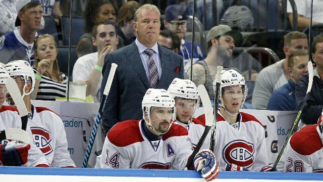 Montreal Canadiens Coach Therrien and players watch as the team loses its first this season.