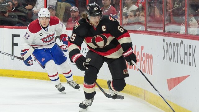 Ottawa Senators defenseman Erik Karlsson (65) skates with the puck as Montreal Canadiens right wing Brendan Gallagher (11) chases in the first period at the Canadian Tire Centre. 