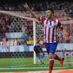 David Villa celebrates scoring a goal for Atletico Madrid