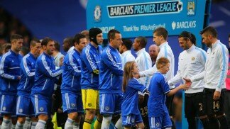 Manchester City and Chelsea players shake hands before a Premier League match