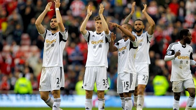 Swansea players applauding fans