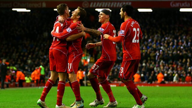 Liverpool players celebrate scoring a goal