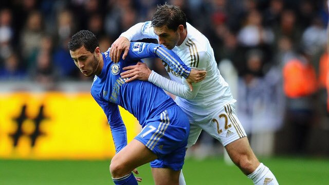 Eden Hazard battling for the ball with Angel Rangel